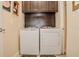 Well-equipped laundry room featuring side-by-side washer and dryer units, offering convenience and efficiency at 1970 Michael Tiago Cir, Maitland, FL 32751