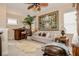 Inviting living room with a bar, sofa, large ornate painting, and unique decorations at 1970 Michael Tiago Cir, Maitland, FL 32751