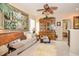 Cozy living room featuring a plush sofa, decorative hutch, ceiling fan, and a large painting enhancing the space at 1970 Michael Tiago Cir, Maitland, FL 32751