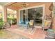Charming covered patio with comfortable seating and lush greenery, perfect for outdoor relaxation and entertaining at 1970 Michael Tiago Cir, Maitland, FL 32751