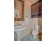 Elegant powder room featuring a pedestal sink, decorative mirror, and complementary fixtures, creating a stylish space at 1970 Michael Tiago Cir, Maitland, FL 32751