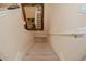 Carpeted staircase with decorative mirror and white railing creates a welcoming and stylish transition between floors at 1970 Michael Tiago Cir, Maitland, FL 32751