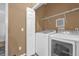 Laundry room with a side-by-side washer and dryer, a storage closet, and neutral paint at 2061 Crestdale Ln # 60, Lake Mary, FL 32746