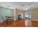 Open living area features hardwood floors, chandelier lighting, and an entertainment area with a television at 2061 Crestdale Ln # 60, Lake Mary, FL 32746