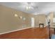 Living room with hardwood floors, ceiling fan, and front door access at 2061 Crestdale Ln # 60, Lake Mary, FL 32746
