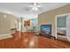 Spacious living room boasting a TV, hardwood floors, and views of the dining area at 2061 Crestdale Ln # 60, Lake Mary, FL 32746