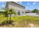 Backyard with grass, a privacy fence, and two palm trees at 2850 Sanderling St, Haines City, FL 33844