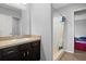 Bathroom with dark vanity, a large mirror, and shower with curtain at 2850 Sanderling St, Haines City, FL 33844