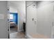Bright bathroom features a white tiled shower and views of a bedroom at 2850 Sanderling St, Haines City, FL 33844