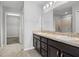 Bathroom featuring double vanity, a large mirror, tile floors, and a walk in shower at 2850 Sanderling St, Haines City, FL 33844
