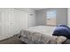 Bedroom features neutral walls, a window with blinds, carpeted floors and a closet at 2850 Sanderling St, Haines City, FL 33844