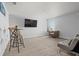 Comfortable bonus room with neutral walls, carpet, seating area with couch, table, chairs, and television at 2850 Sanderling St, Haines City, FL 33844