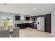 Well-lit kitchen with dark cabinetry, stainless steel appliances, and adjacent dining area at 2850 Sanderling St, Haines City, FL 33844