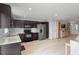 Spacious kitchen with dark cabinets, stainless steel appliances, and a view into the living area at 2850 Sanderling St, Haines City, FL 33844