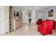 Bright living room with light wood floors, comfortable red chairs, and neutral walls at 2850 Sanderling St, Haines City, FL 33844