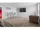 Large living room with plush carpeting, couches, chairs, and a TV at 2850 Sanderling St, Haines City, FL 33844