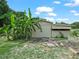 Exterior view of a barn with an awning and lush greenery in a wooded setting with blue skies at 2921 W Socrum Loop Rd, Lakeland, FL 33810