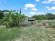The barn has a small awning and is surrounded by lush vegetation, creating a tropical oasis at 2921 W Socrum Loop Rd, Lakeland, FL 33810