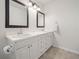 Bright bathroom featuring double sinks with framed mirrors and white cabinetry at 2921 W Socrum Loop Rd, Lakeland, FL 33810