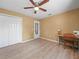Bedroom featuring light-colored wood flooring, a ceiling fan, and neutral walls at 2921 W Socrum Loop Rd, Lakeland, FL 33810