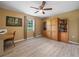 Bedroom featuring light-colored wood flooring, a ceiling fan, and a large window at 2921 W Socrum Loop Rd, Lakeland, FL 33810