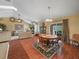 Open dining area with hardwood floors, round table, and sliding door to the backyard at 2921 W Socrum Loop Rd, Lakeland, FL 33810
