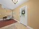 Inviting entryway with tile and wood flooring, decorative chair, and a view to the front yard at 2921 W Socrum Loop Rd, Lakeland, FL 33810