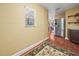 Hallway with wood floors leading to stainless refrigerator and kitchen area at 2921 W Socrum Loop Rd, Lakeland, FL 33810