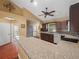 Open kitchen showcasing breakfast bar, stainless steel appliances, and arched doorway at 2921 W Socrum Loop Rd, Lakeland, FL 33810