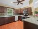 Well-equipped kitchen with dark wood cabinets, modern appliances, and a bright window at 2921 W Socrum Loop Rd, Lakeland, FL 33810