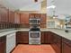 Well-lit kitchen featuring stainless steel appliances, dark wood cabinetry, and granite countertops at 2921 W Socrum Loop Rd, Lakeland, FL 33810