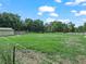 A sprawling green field bordered by mature trees and white fencing creates an idyllic and tranquil landscape at 2921 W Socrum Loop Rd, Lakeland, FL 33810