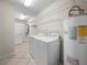Functional laundry room with modern washer, dryer, and ample shelving at 2921 W Socrum Loop Rd, Lakeland, FL 33810
