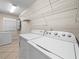 Functional laundry room with modern washer, dryer, and ample shelving at 2921 W Socrum Loop Rd, Lakeland, FL 33810