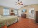 Spacious main bedroom featuring wood floors, vaulted ceiling, and ensuite bathroom at 2921 W Socrum Loop Rd, Lakeland, FL 33810