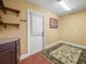 Mud room featuring a door with blinds, wood flooring and a floral area rug at 2921 W Socrum Loop Rd, Lakeland, FL 33810