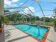 Sparkling pool with a screened enclosure and lush tropical landscaping at 2921 W Socrum Loop Rd, Lakeland, FL 33810