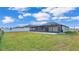 The backyard features a large screened patio for relaxing and enjoying the outdoors at 2966 Flying Blackbird Rd, Bartow, FL 33830