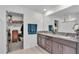 Bathroom with dual sinks, granite countertops, dark cabinetry, and walk-in closet at 2966 Flying Blackbird Rd, Bartow, FL 33830