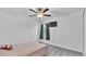 Simple bedroom with neutral tones, a ceiling fan and a window with curtains at 2966 Flying Blackbird Rd, Bartow, FL 33830
