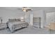 Bright, carpeted bedroom with neutral walls, ceiling fan, and standard closet at 2966 Flying Blackbird Rd, Bartow, FL 33830