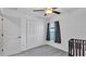 Bright bedroom features a ceiling fan, closet, window, and gray carpet at 2966 Flying Blackbird Rd, Bartow, FL 33830