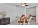 Dining area with table, chairs, cabinet, and a ceiling fan providing a comfortable setting at 2966 Flying Blackbird Rd, Bartow, FL 33830