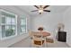 Cozy dining area with wood table, white chairs, and natural light from two windows at 2966 Flying Blackbird Rd, Bartow, FL 33830