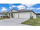 Inviting single-story home featuring a spacious driveway and two-car garage at 2966 Flying Blackbird Rd, Bartow, FL 33830