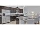 Modern kitchen with stainless steel appliances, granite countertops, and barstool seating at the island at 2966 Flying Blackbird Rd, Bartow, FL 33830