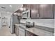 Modern kitchen features stainless steel appliances, granite counters, and dark cabinets at 2966 Flying Blackbird Rd, Bartow, FL 33830