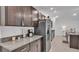 Well-equipped kitchen with stainless steel appliances, granite countertops, and dark wood cabinets at 2966 Flying Blackbird Rd, Bartow, FL 33830