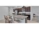 Bright kitchen featuring a large island, stainless steel appliances, and dark wood cabinetry at 2966 Flying Blackbird Rd, Bartow, FL 33830