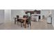 Open-concept kitchen and dining area with stainless steel appliances and barstool seating at 2966 Flying Blackbird Rd, Bartow, FL 33830